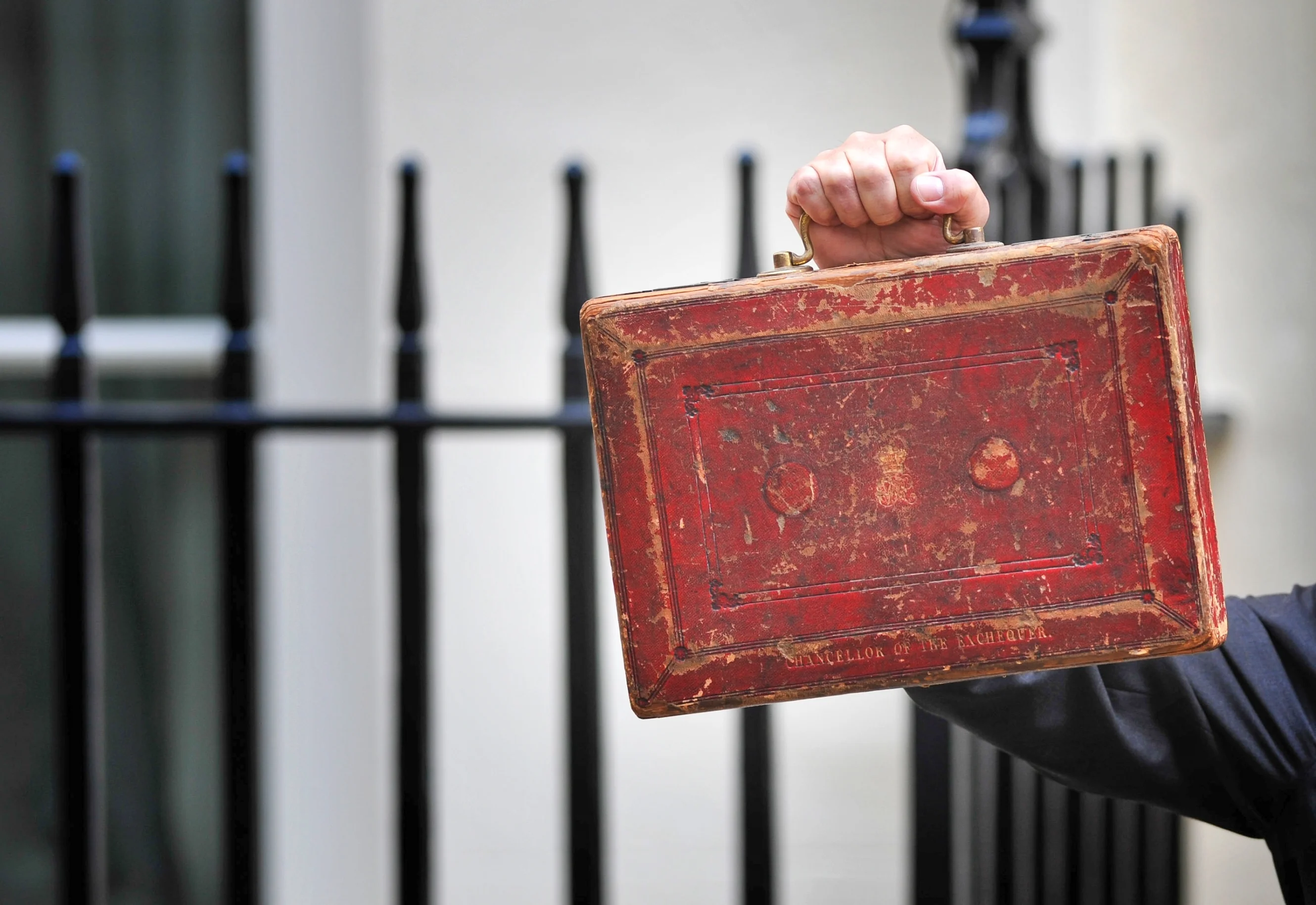 Someone holding up the budget suitcase