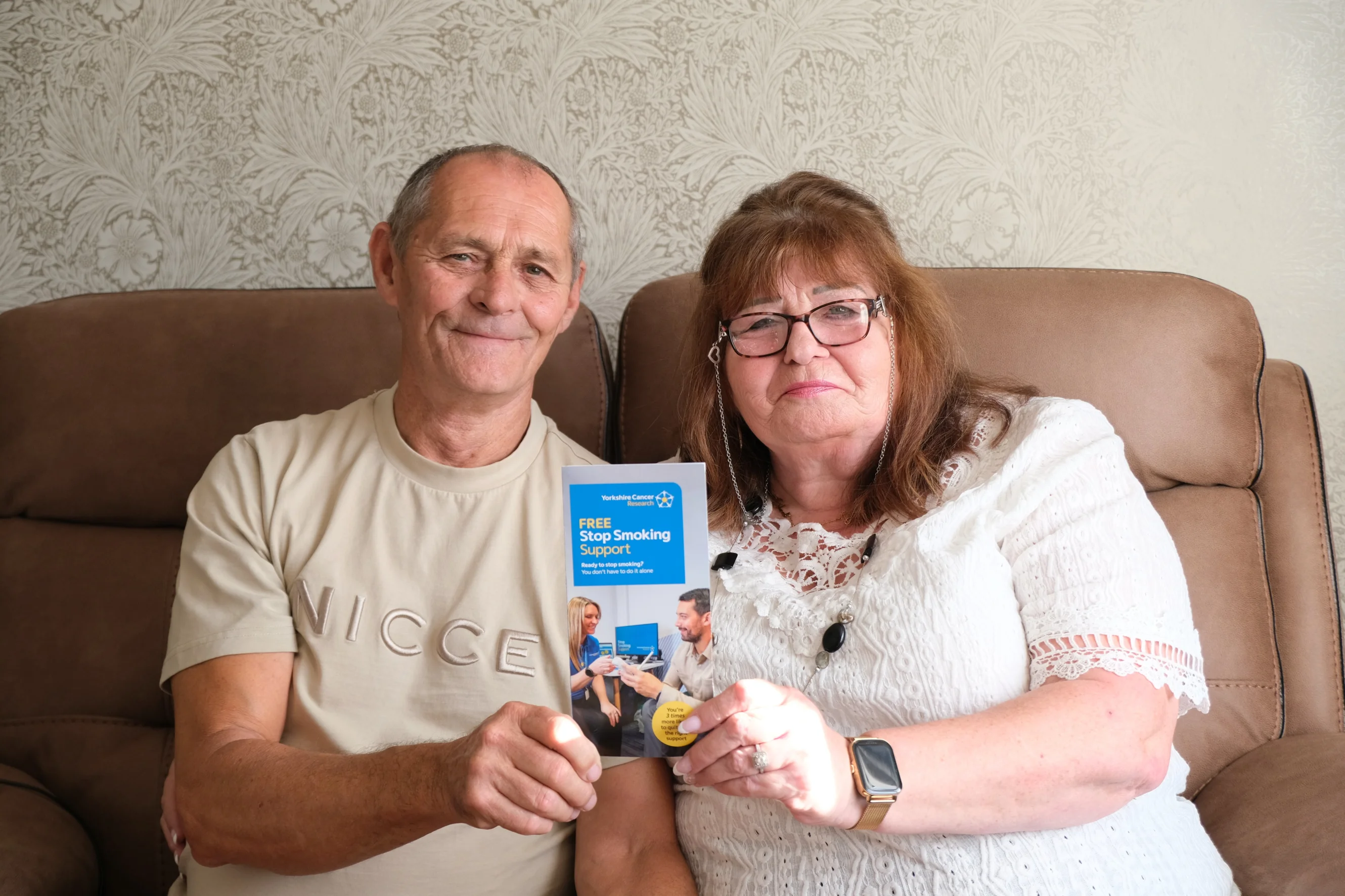 Linda and Terry holding a stop smoking support leaflet