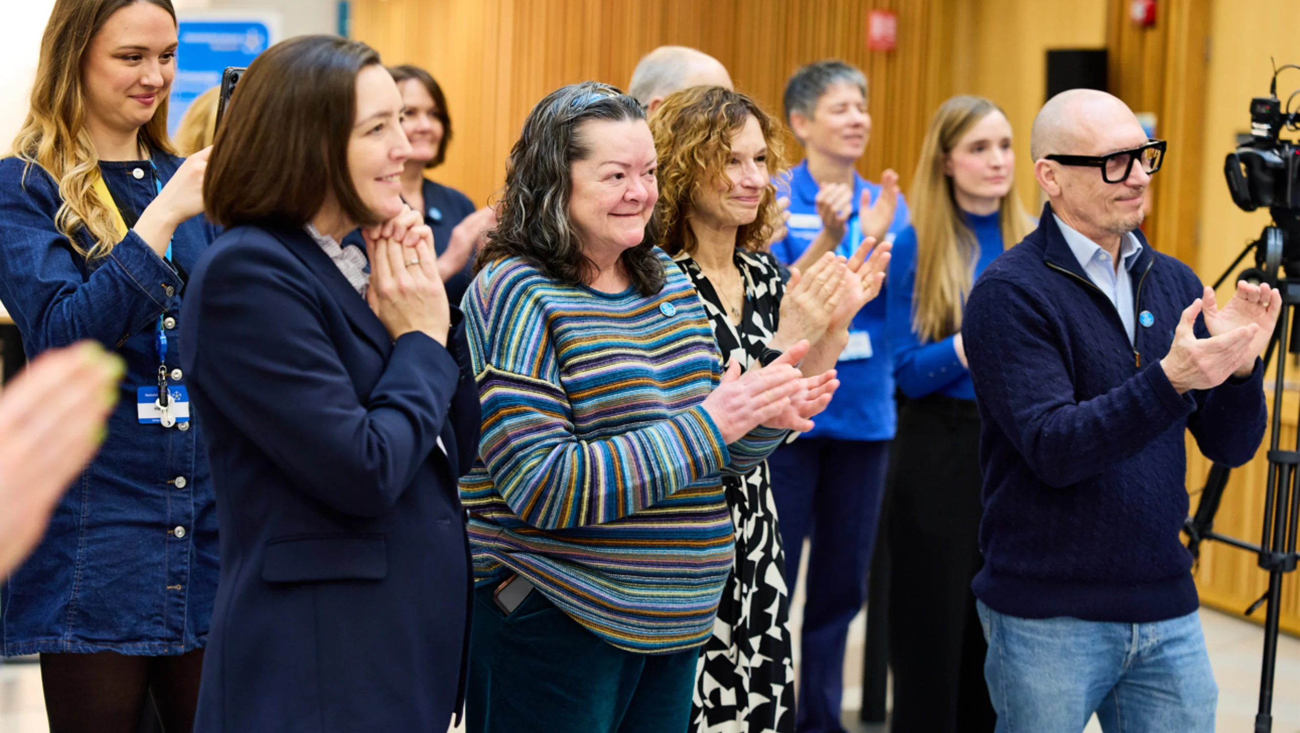 Supporters clap at the launch of Simon's poem