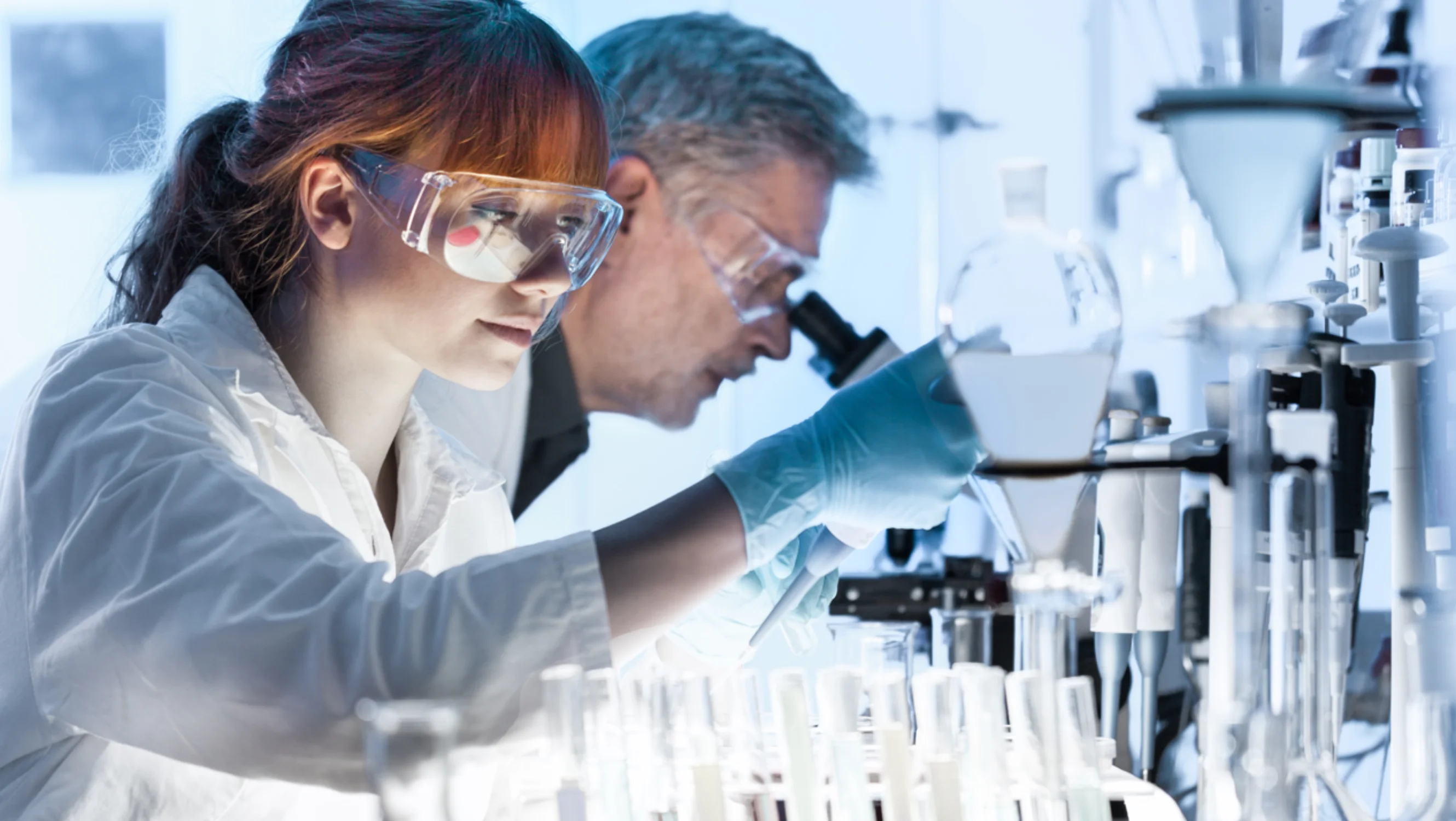 Researcher looking at a test tube