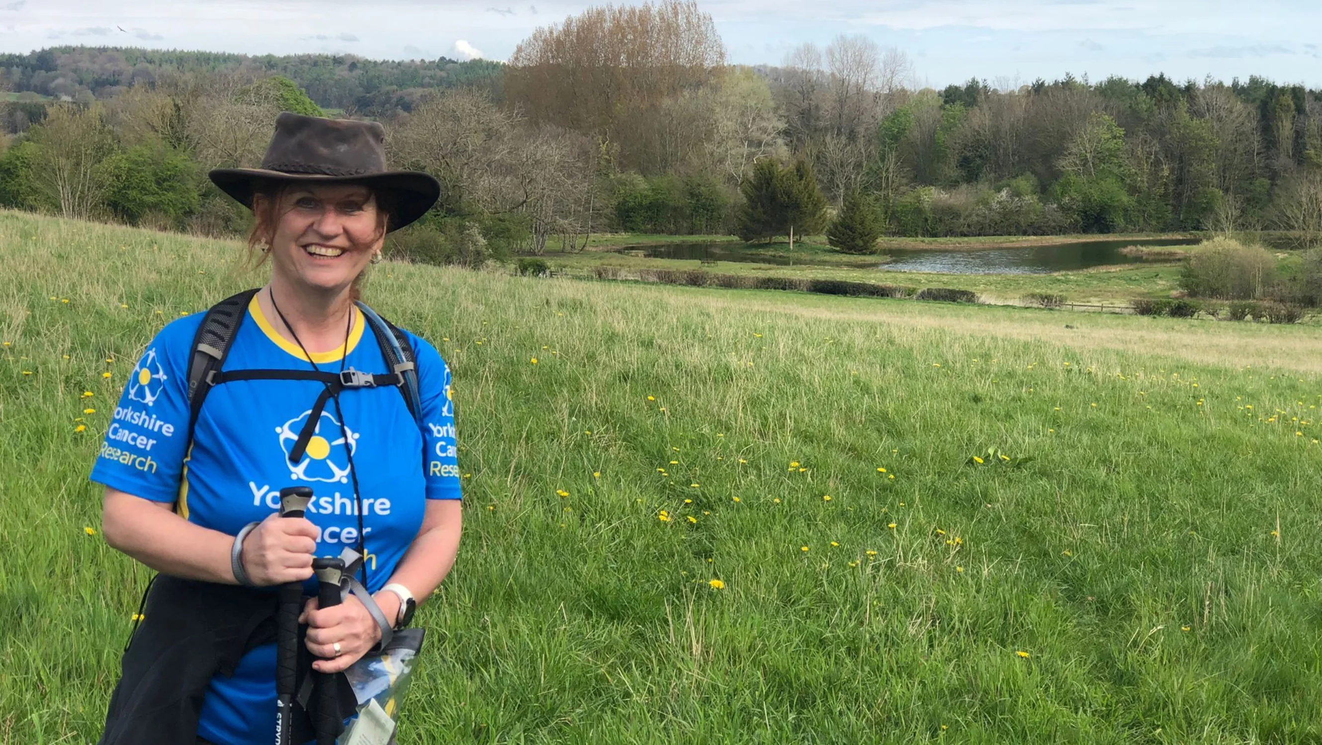 Jackie standing in a field on her walk
