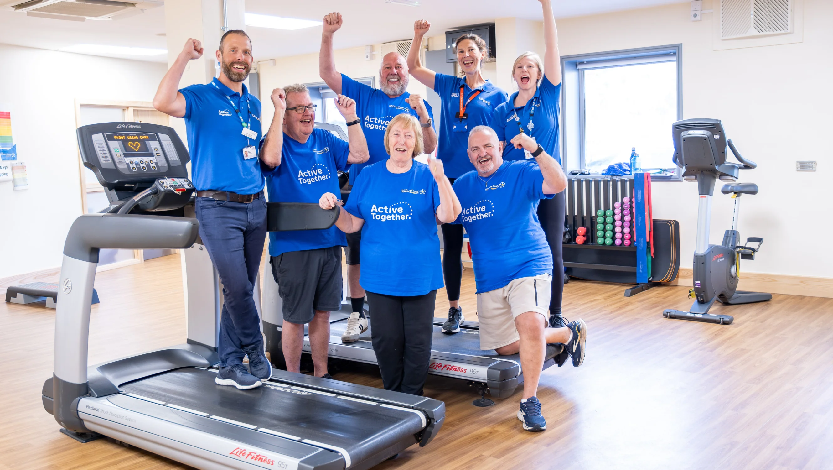 Active Together group with hands in the air