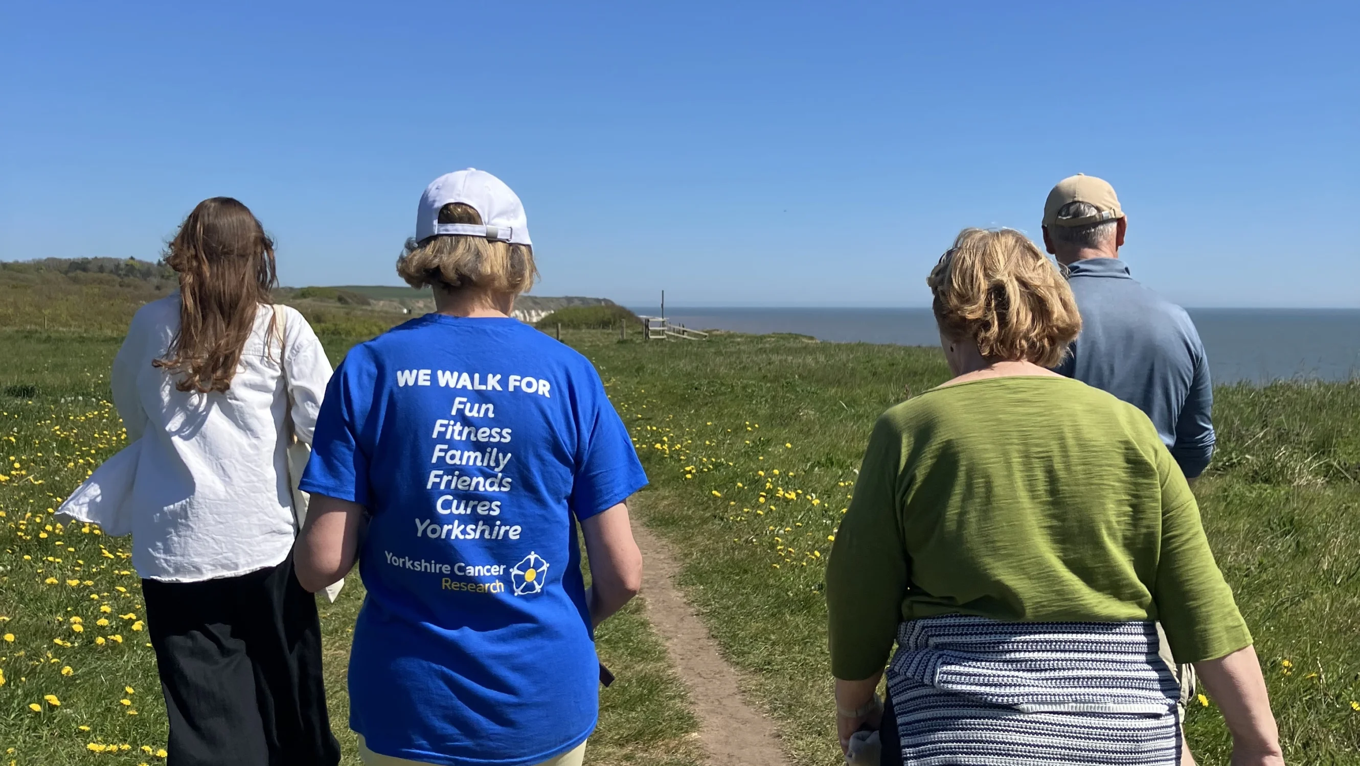Josie and her parkrun friends walking along the coast