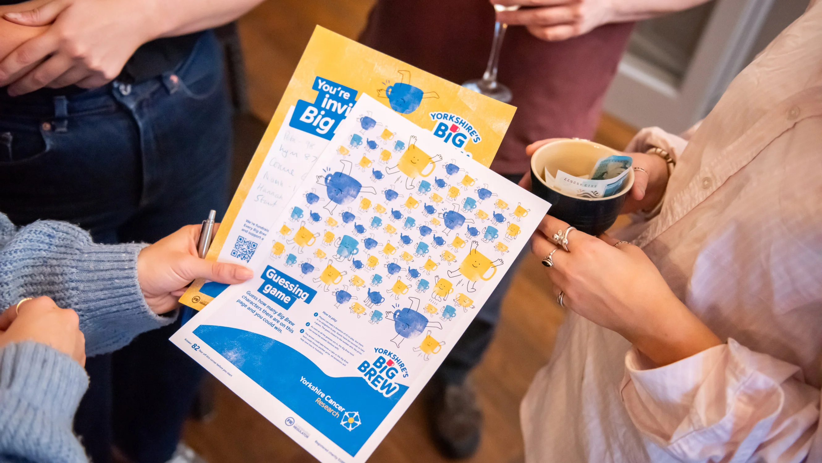 Someone holding resources from the Big Brew fundraising pack