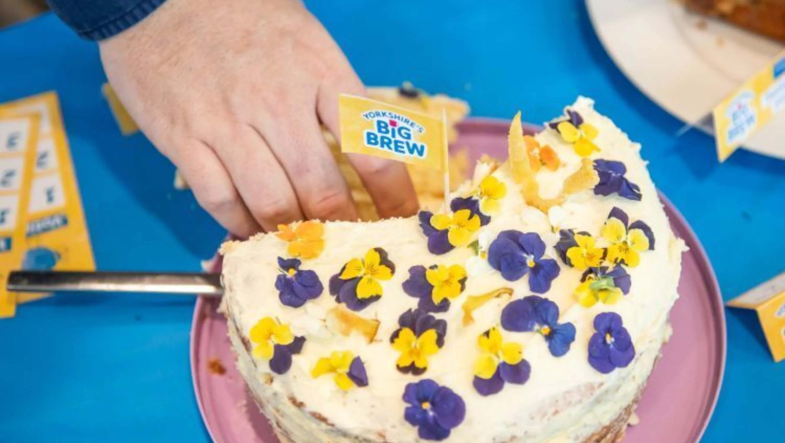 Someone putting a flag in a cake