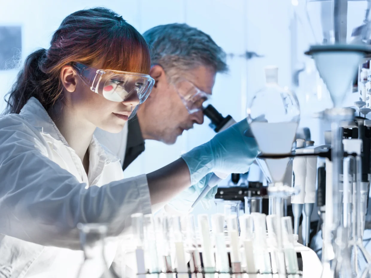 Researcher looking at a test tube