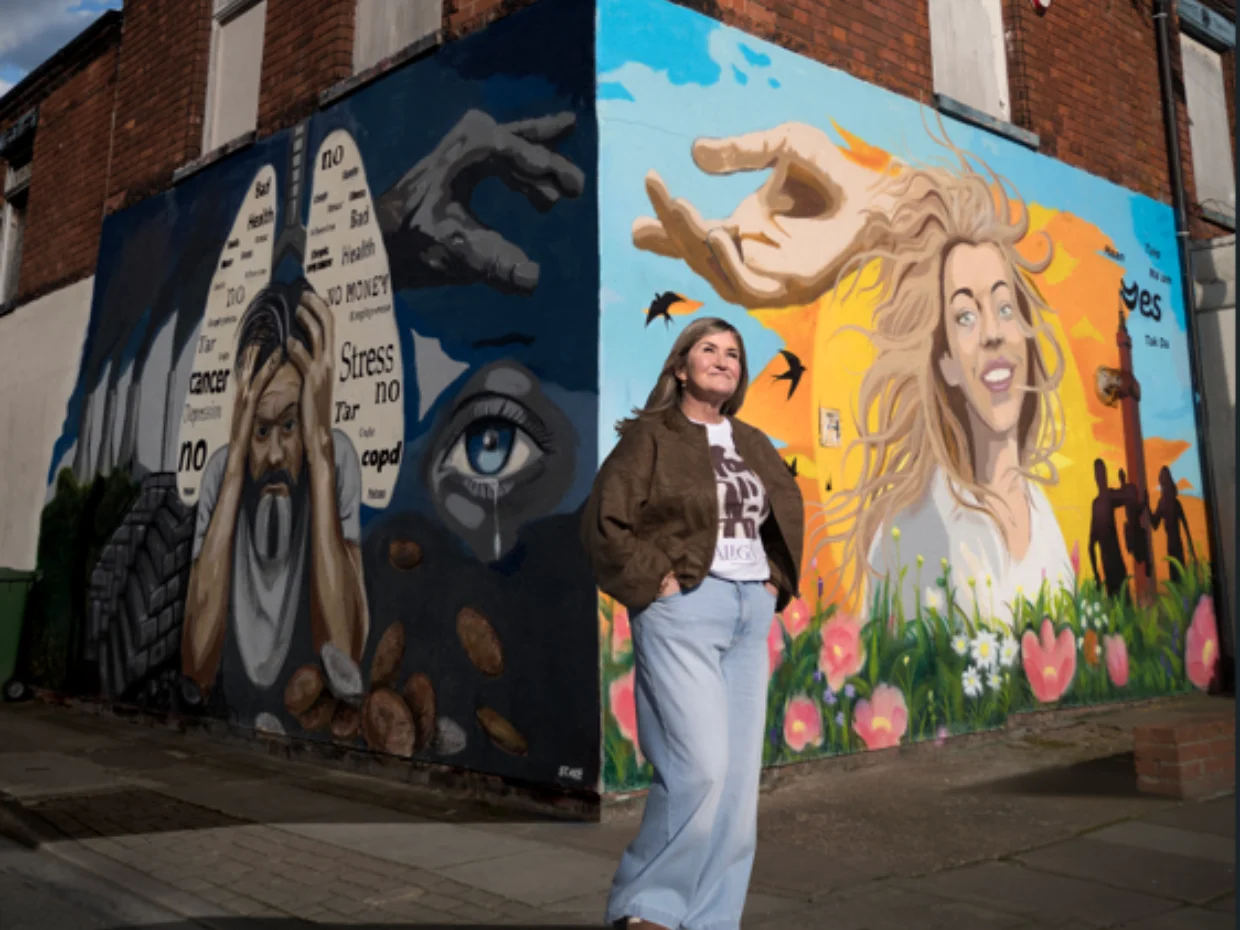 Wendy standing in front of the 'Turn the Corner' campaign wall